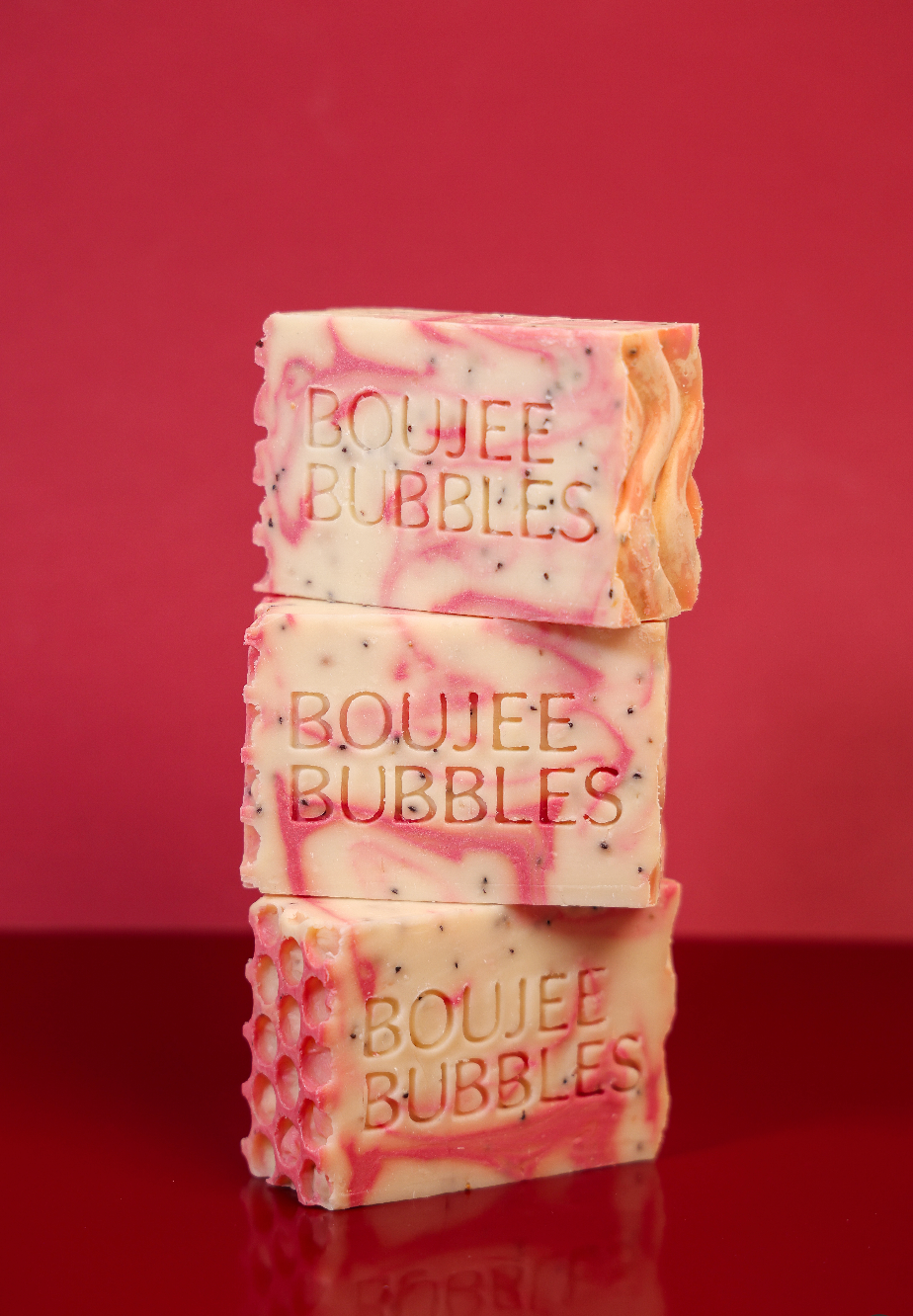 Stack of 'Boujee Bubbles' soap bars on a red background